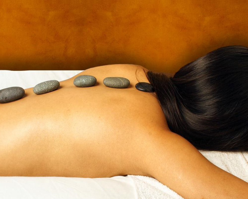 Woman Receiving Hot Stone Massage Woman Receiving Hot Stone Massage